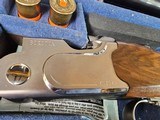 9065
Beretta 692, 12 gauge, 30” barrels, 6 chokes (2 Skeet, IC, M, IM, LM, CL) cleaning rod, 2 snap caps, Beretta ASE AAA fancy walnut, vent rib, but - 6 of 25