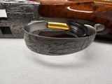 9067
Browning FN Superposed Diana Grade!!
SUPER RARE..
By R Kowalski Master Engraver, signed on BOTH Sides, Made in 1969, 2 3/4 chambers, 30” venti - 11 of 25