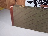 9222
Winchester green shotgun trunk style case with red interior, New old stock, will hot up to a 26” barrel.
With original keys and key fob.More pi - 18 of 18