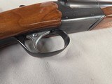 9268
Ithaca 100 20 gauge, 28” barrels, M/F, single selective trigger, pistol grip with cap, butt plate, scalloped receiver, red optic front site, 14 - 21 of 25