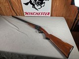 9268
Ithaca 100 20 gauge, 28” barrels, M/F, single selective trigger, pistol grip with cap, butt plate, scalloped receiver, red optic front site, 14