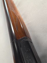 9268
Ithaca 100 20 gauge, 28” barrels, M/F, single selective trigger, pistol grip with cap, butt plate, scalloped receiver, red optic front site, 14 - 19 of 25