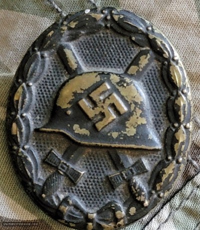 German WW II black wound badge early version of pressed brass painted black.