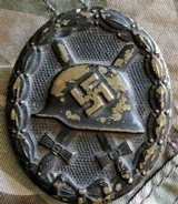 German WW II black wound badge early version of pressed brass painted black.