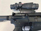 Smith and Wesson M&P 15 .556 caliber rifle with Trijicon ACOG TA31RCO-A4 Optic, sling, hard case and eleven magazines - 7 of 10